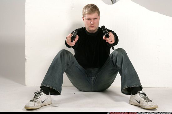 Man Young Average White Fighting with gun Sitting poses Sportswear