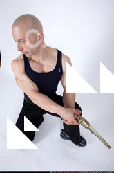 Man Adult Muscular White Fighting with gun Kneeling poses Sportswear