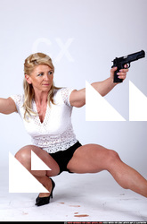 Woman Adult Muscular White Fighting with gun Kneeling poses Sportswear