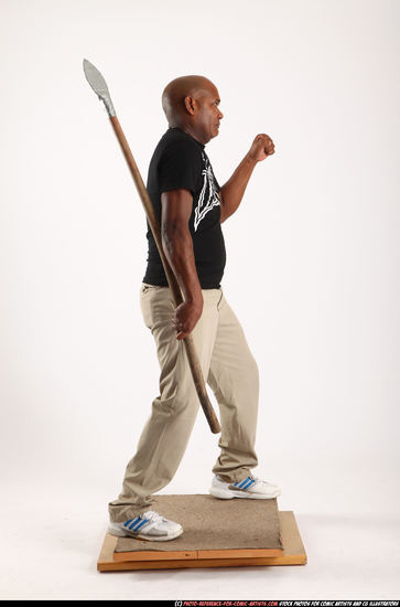 Man Old Average Black Fighting with spear Standing poses Casual
