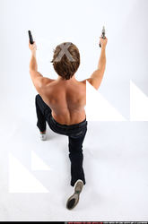 2010 09 PATRICK KNEELING SHOOTING DUAL PISTOLS 04 A