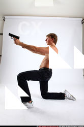 2010 09 PATRICK KNEELING SHOOTING DUAL PISTOLS 02 C