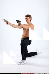 2010 09 PATRICK KNEELING SHOOTING DUAL PISTOLS 01 B