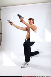 2010 09 PATRICK KNEELING SHOOTING DUAL PISTOLS 01 C