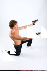 2010 09 PATRICK KNEELING SHOOTING DUAL PISTOLS 06 A