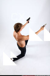 2010 09 PATRICK KNEELING SHOOTING DUAL PISTOLS 05 A