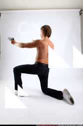 2010 09 PATRICK KNEELING SHOOTING DUAL PISTOLS 03 C