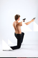 2010 09 PATRICK KNEELING SHOOTING DUAL PISTOLS 05 B