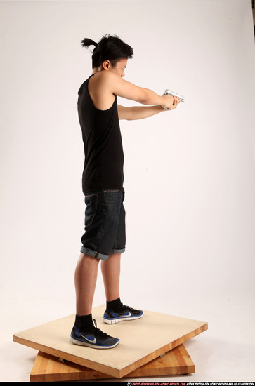 Man Young Athletic Fighting with gun Standing poses Casual Asian