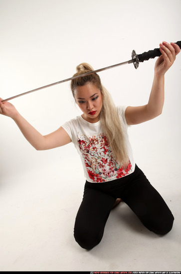 Woman Young Average Fighting with sword Kneeling poses Casual Asian