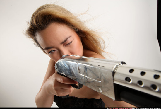 Woman Young Average Standing poses Casual Asian Fighting with shotgun