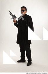Man Adult Average Black Fighting with gun Standing poses Coat