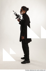 Man Adult Average Black Fighting with gun Standing poses Coat