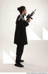 Man Adult Average Black Fighting with gun Standing poses Coat