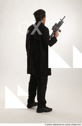 Man Adult Average Black Fighting with gun Standing poses Coat