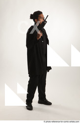 Man Adult Average Black Fighting with gun Standing poses Coat