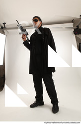 Man Adult Average Black Fighting with gun Standing poses Coat