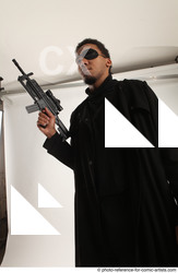 Man Adult Average Black Fighting with gun Standing poses Coat
