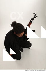 Man Adult Average Black Fighting with gun Sitting poses Coat