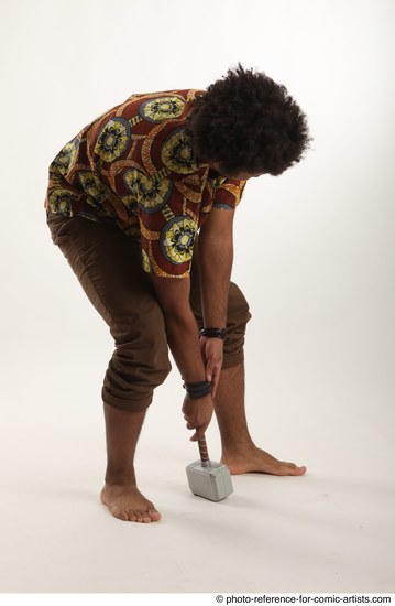 Man Adult Average Black Fighting with hammer Crouching Coat