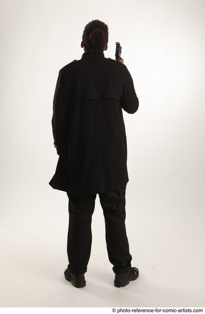 Man Adult Average Black Fighting with gun Standing poses Coat