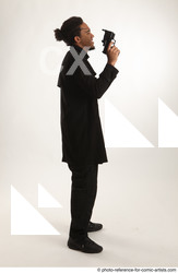 Man Adult Average Black Fighting with gun Standing poses Coat