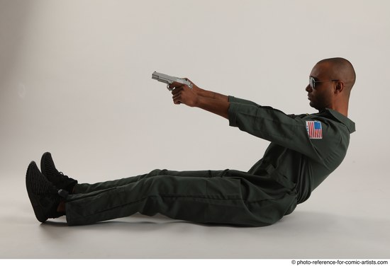 Man Adult Average Black Fighting with gun Sitting poses Casual
