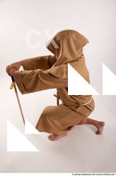11 2018 01 JOEL ADAMSON MONK KNEELING POSE WITH SWORD