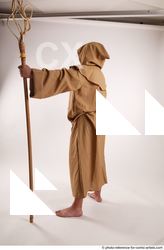 12 2019 01 JOEL ADAMSON MONK STANDING POSE WITH A…