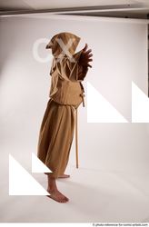 15 2019 01 JOEL ADAMSON MONK STANDING POSE WITH A…