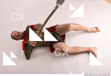 Man Adult Average White Fighting with spear Laying poses Casual