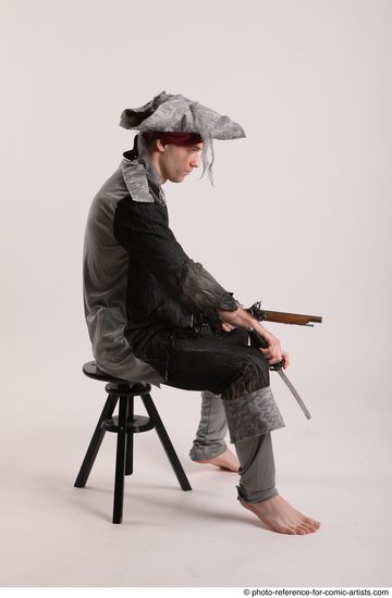 Man Adult Average White Fighting with gun Sitting poses Coat