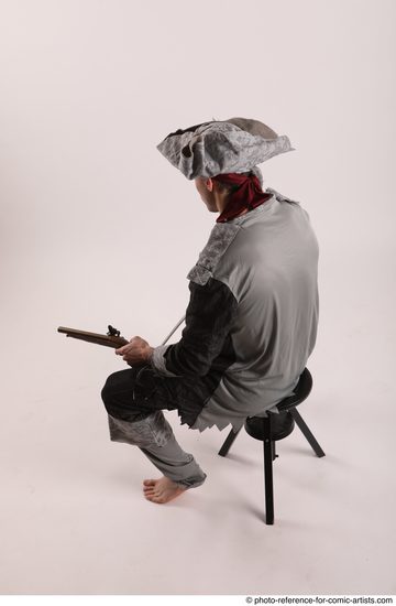 Man Adult Average White Fighting with gun Sitting poses Coat