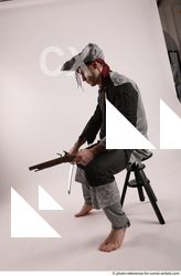 Man Adult Average White Fighting with gun Sitting poses Coat