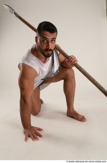Man Adult Muscular Fighting with spear Kneeling poses Coat Latino