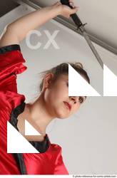 Woman Adult Average Fighting with sword Standing poses Coat Latino