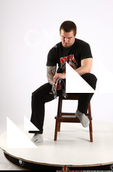 Alex Sitting With Pistol Pose