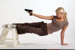 Woman Adult Athletic White Fighting with gun Moving poses Sportswear