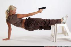 Woman Adult Athletic White Fighting with gun Moving poses Sportswear