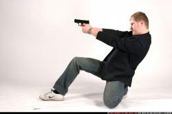 Man Adult Average White Fighting with gun Kneeling poses Sportswear