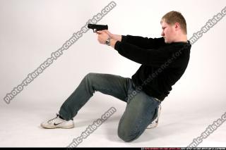 Janisone kneeling leaning aiming