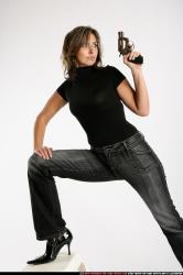 Woman Adult Average White Fighting with gun Standing poses Sportswear