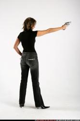 Woman Adult Average White Fighting with gun Standing poses Sportswear