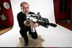 Man Old Chubby White Fighting with submachine gun Kneeling poses Casual