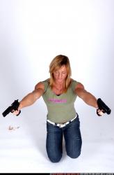 Woman Adult Muscular White Fighting with gun Kneeling poses Sportswear