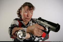 Woman Old Average White Fighting with gun Sitting poses Casual