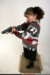 Woman Old Average White Fighting with gun Sitting poses Casual