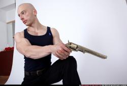 Man Adult Muscular White Fighting with gun Kneeling poses Sportswear