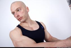 Man Adult Muscular White Fighting with gun Kneeling poses Sportswear