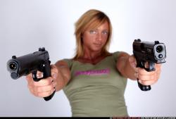 Woman Adult Muscular White Fighting with gun Sitting poses Sportswear